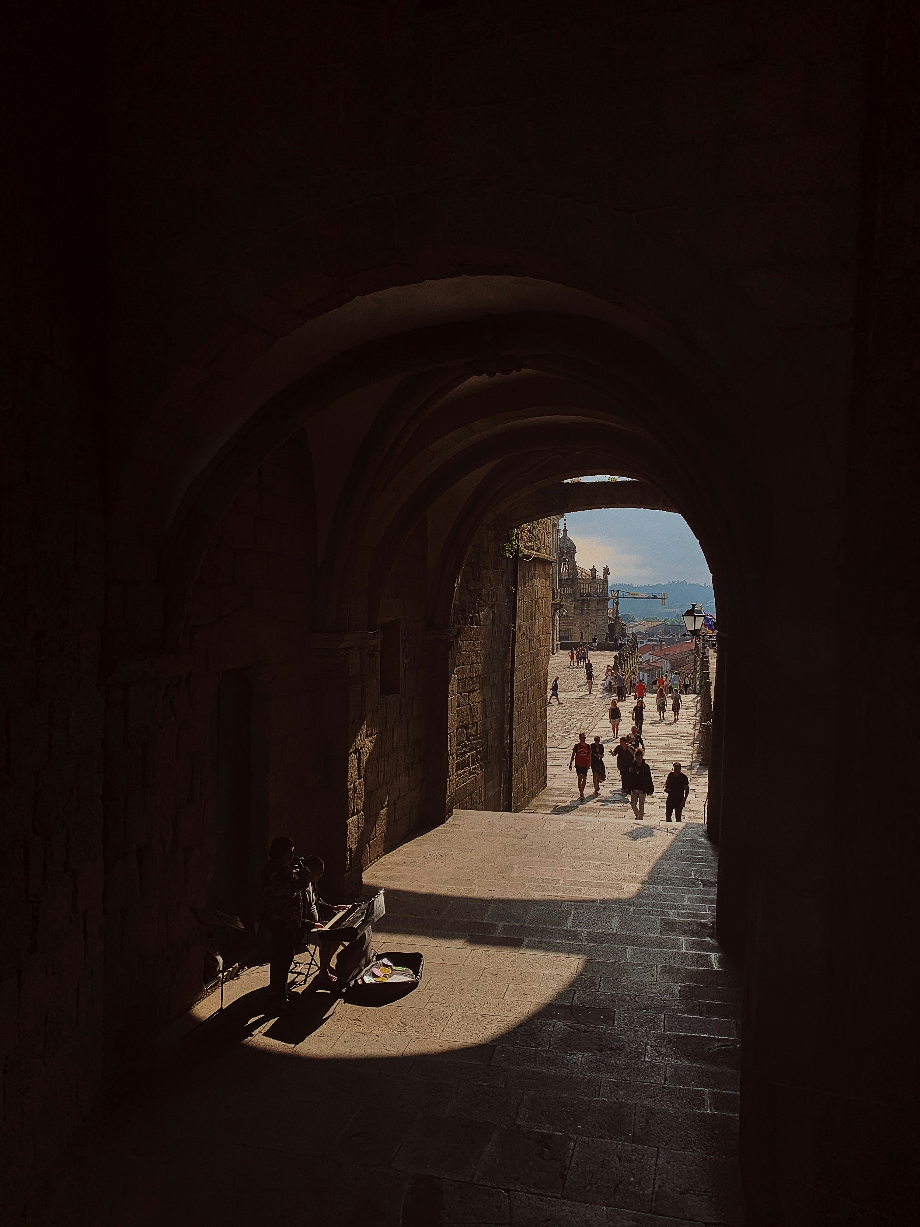 people walking near concrete tunnel building